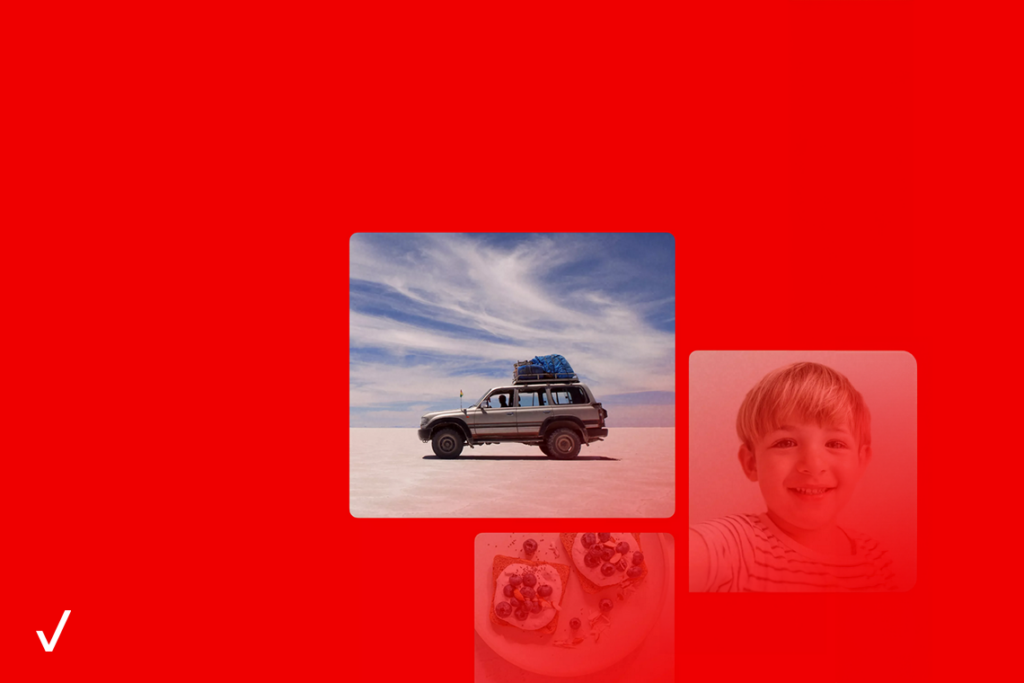 An SUV with gear packed on top, on a desert landscape against a cloudy blue sky.